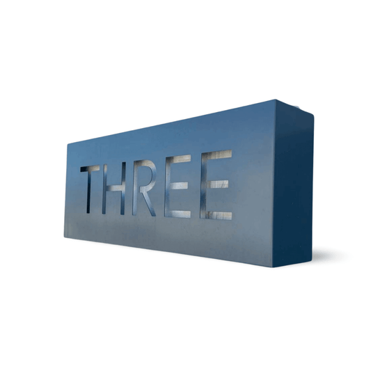 Stylish house number three in modern design, made from durable aluminium for home exterior decoration.